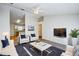 Cozy living room with modern furniture, a stylish rug, and views into the kitchen at 441 Danube Dr, Kissimmee, FL 34759