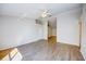 The empty living room has wood-look flooring, a ceiling fan, and a large window at 441 Danube Dr, Kissimmee, FL 34759