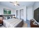 Stylish main bedroom featuring a gray headboard bed, ceiling fan and spacious closet at 441 Danube Dr, Kissimmee, FL 34759