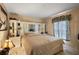 Main bedroom with large mirrored dresser and window coverings at 6900 Sw 137Th Court Rd, Ocala, FL 34481