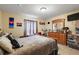 Bright bedroom with a comfortable bed, dresser, and window coverings at 6900 Sw 137Th Court Rd, Ocala, FL 34481