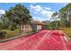 Red stained concrete driveway and partial view of home at 6900 Sw 137Th Court Rd, Ocala, FL 34481