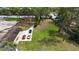 Aerial view of a property showcasing its large yard, driveway, and proximity to surrounding trees and roads at 11326 Westwood Blvd, Orlando, FL 32821