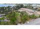 Aerial view of the property with nearby lake, surrounding trees, and adjacent construction site at 11326 Westwood Blvd, Orlando, FL 32821