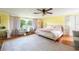 Bright bedroom featuring light yellow walls, a large area rug, and a king-sized bed with pale pink accents at 11326 Westwood Blvd, Orlando, FL 32821