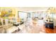 Open dining area with modern glass table, chairs and view to an adjoining living area at 11326 Westwood Blvd, Orlando, FL 32821