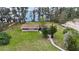 An aerial view of a single-story home featuring a large front yard, mature trees, and brick construction at 11326 Westwood Blvd, Orlando, FL 32821