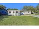 Ranch style home with gray exterior, landscaping, and driveway at 1236 Merritt St, Altamonte Springs, FL 32701