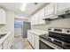 Modern white kitchen with stainless steel appliances and quartz countertops at 1236 Merritt St, Altamonte Springs, FL 32701