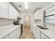 White kitchen with stainless steel appliances and quartz countertops at 1236 Merritt St, Altamonte Springs, FL 32701