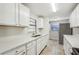 White kitchen cabinets, stainless steel appliances, and quartz countertops at 1236 Merritt St, Altamonte Springs, FL 32701