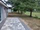 Outdoor patio area perfect for entertaining or relaxing, overlooking a spacious backyard with lush greenery at 15613 Greater Groves Blvd, Clermont, FL 34714