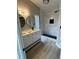 Contemporary bathroom featuring dual sinks, modern lighting, and a stylish walk-in shower with updated finishes at 15613 Greater Groves Blvd, Clermont, FL 34714