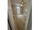 Bright bedroom featuring modern flooring, a ceiling fan, and a large window for natural light at 15613 Greater Groves Blvd, Clermont, FL 34714