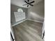 Bright bedroom featuring modern flooring, a ceiling fan, and a large window for natural light at 15613 Greater Groves Blvd, Clermont, FL 34714