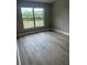 Bright bedroom featuring modern flooring, and a large window for natural light at 15613 Greater Groves Blvd, Clermont, FL 34714