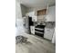Modern kitchen with stainless steel appliances, new cabinets, and stone countertops at 15613 Greater Groves Blvd, Clermont, FL 34714