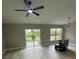 Bright living room featuring new floors, neutral paint, ceiling fan, and lots of natural light at 15613 Greater Groves Blvd, Clermont, FL 34714
