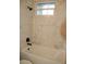 Bathroom with bathtub and marble-look tile at 1712 Lake Alden Dr, Apopka, FL 32712
