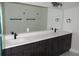 Double vanity with quartz countertop and dark brown cabinets at 1712 Lake Alden Dr, Apopka, FL 32712