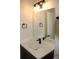 Bathroom vanity with quartz countertop and dark cabinets at 1712 Lake Alden Dr, Apopka, FL 32712