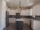 Modern kitchen with white cabinets, island, and mosaic backsplash at 1712 Lake Alden Dr, Apopka, FL 32712