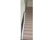 Elegant carpeted staircase with black metal railing at 1712 Lake Alden Dr, Apopka, FL 32712