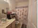 Clean bathroom with a shower/tub combo and leopard print decor at 501 Heritage Trail St, Kissimmee, FL 34759