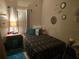 Cozy bedroom with double bed and decorative wall accents at 501 Heritage Trail St, Kissimmee, FL 34759