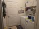 Laundry room with washer, dryer, and ample storage shelving at 501 Heritage Trail St, Kissimmee, FL 34759