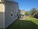 Outdoor patio with seating area, umbrella, and lush green lawn at 501 Heritage Trail St, Kissimmee, FL 34759