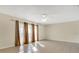 Bright living room with tile floors, ceiling fan, and neutral walls, illuminated by natural light at 7201 Pleasant Dr, Orlando, FL 32818