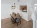 Dining room with a modern chandelier fixture, table set for six and view of the kitchen at 10763 Regent Square Dr # 1903, Orlando, FL 32825