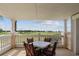 Covered balcony with table and chairs overlooking the golf course at 1364 Centre Court Ridge Dr # 201, Reunion, FL 34747