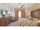 King-size bed, large windows and ensuite bathroom at 1364 Centre Court Ridge Dr # 201, Reunion, FL 34747