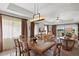 Elegant dining area with a glass-top table and wood chairs at 1364 Centre Court Ridge Dr # 201, Reunion, FL 34747