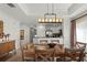 Bright dining room features a glass-top table and modern chandelier at 1364 Centre Court Ridge Dr # 201, Reunion, FL 34747