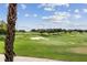 Expansive green golf course with palm trees and blue sky at 1364 Centre Court Ridge Dr # 201, Reunion, FL 34747