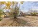 The backyard showcases mature trees and partial fencing at 14025 Royal Fern Way, Astatula, FL 34705