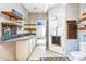 Bathroom with dual sinks, overhead mirror, and open doorway at 14025 Royal Fern Way, Astatula, FL 34705