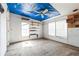 A spacious bedroom with built in shelves and a ceiling covered with a blue tarp at 14025 Royal Fern Way, Astatula, FL 34705