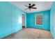 Bedroom with blue walls, a window, and carpet flooring at 14025 Royal Fern Way, Astatula, FL 34705