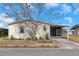 Street view of a light yellow single-story home with front landscaping at 14025 Royal Fern Way, Astatula, FL 34705