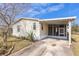 Charming single-story home featuring a screened-in carport and nicely landscaped yard at 14025 Royal Fern Way, Astatula, FL 34705