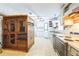 Outdated kitchen with wallpaper, wood cabinets, laminate counters and a small window at 14025 Royal Fern Way, Astatula, FL 34705