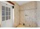 Tan walled laundry room featuring a window, door and electrical components at 14025 Royal Fern Way, Astatula, FL 34705