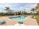 A community pool with brick pavers, palm trees, pool house and lots of seating at 14025 Royal Fern Way, Astatula, FL 34705