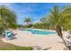 Community pool with lounge chairs and lush palm trees at 14025 Royal Fern Way, Astatula, FL 34705