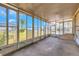 The screened sunroom has an exterior door and concrete flooring at 14025 Royal Fern Way, Astatula, FL 34705