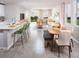 Open concept dining area with wood table and green chairs, overlooking the living room at 1620 Leamington Ln, Winter Haven, FL 33884